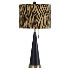 a lamp that has a zebra print shade on it and a black base with a gold trim