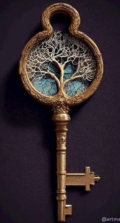 a golden key with a tree on it is hanging from the side of a wall