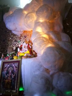 there is a large cloud made out of cotton balls and other items on the table