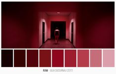 a person standing in the middle of a hallway with red walls and floor paint colors