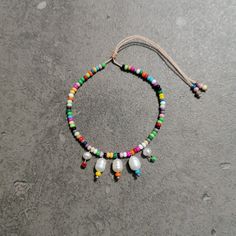 a multicolored beaded necklace on a string