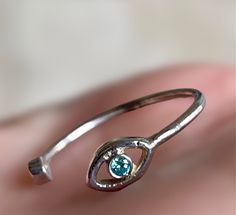 This ring is 100% silver. The adjustable nature of the band allows for comfortable fit on various finger sizes including the pinky. The combination of the eye motif and turquoise stone gives it a unique and protective appearance often associated with warding off negative energy. Adjustable Spiritual Turquoise Open Ring, Adjustable Spiritual Open Turquoise Ring, Adjustable Silver Turquoise Ring With Birthstone, Adjustable Sterling Silver Evil Eye Ring, Eye Motif, Eye Ring, Negative Energy, Turquoise Stone, Rings Statement