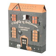 a cardboard halloween house with pumpkins and jack - o'- lanterns on it