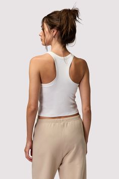 From the street or to sleep. A fitted, Cropped-length tank designed in a racerback cut with an attached interior bra layer. Made in our light and fluid signature Slim Rib fabric, which offers maximum flexibility, softness, and breathability with compressive support. | Tori Rib Tank Top in Stone Casual Halter Top With Built-in Bra And Racerback, Casual Racerback Halter Top With Built-in Bra, Casual Tank Top With Built-in Bra And Medium Support, Athleisure Tank Top With Built-in Bra, Fitted White Racerback Camisole, White Fitted Racerback Camisole, White Sleeveless Bra-friendly Halter Top, Spring Stretch Racerback Camisole, Stretch Racerback Camisole For Spring