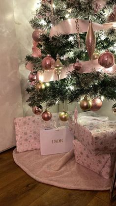 a small christmas tree with presents under it