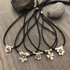 Unique one of a kind silver flower charms choker. 10 different necklaces, made with a long black leather cord and 10 unique silver flower pendants with silver beads. This necklaces can be adjusted to chokers or can be long necklaces like you can see in the picture. Perfect stacking necklaces that will rock your outfit and will be easy to match other accessories. You can see in 2 of the pictures that each flower choker has a number, that way you know which one are choosing. A unique addition to y Minimalist Adjustable Charm Necklace With Flower Pendant, Minimalist Adjustable Flower Pendant Necklace, Minimalist Adjustable Flower Necklace, Flower Shaped Jewelry With Adjustable Cord As A Gift, Minimalist Adjustable Necklace With Flower Pendant, Dainty Adjustable Charm Necklaces With Flower Pendant, Minimalist Adjustable Jewelry With Flower Charm, Dainty Adjustable Charm Necklace With Flower Pendant, Adjustable Flower Necklace Nickel Free