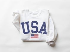 USA Sweatshirt, America Shirt, 4th Of July Shirt Women, USA Shirt, Women Military, Patriotic Shirt, Women Sweatshirt, 4th of July Party Outfit, USA Outfit, 4th of July Sweatshirt, USA shirt, Womens 4th of July, America Shirt, 4th of July, Patriotic Shirt, Red White and Blue, 4th of July Pullover Our trendy U.S. grown cotton unisex crewneck sweatshirts are made to order and are designed, printed, pressed and shipped from us to you! The fabric is a 50/50 blend and printed using eco-friendly water-based inks resulting in super comfy sweatshirts with soft, breathable prints that last over time. 📏 Sizing  All of our sweatshirts are unisex and fit great on both men and women. Please take a look at our sizing chart included in the images for measurements. 📋 Production & Shipping Time ► Producti Relaxed Fit Graphic Print Sweatshirt For 4th Of July, Long Sleeve Cotton Tops For 4th Of July, Cotton Long Sleeve Top For 4th Of July, Patriotic Letter Print Sweatshirt For Independence Day, White Crew Neck Sweatshirt For 4th Of July, White Long Sleeve Tops For Independence Day, Patriotic White Cotton Sweatshirt, Independence Day Crew Neck Sweatshirt With Letter Print, Long Sleeve Relaxed Fit T-shirt For 4th Of July