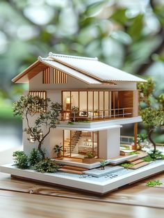 a model house on top of a tabletop with trees in the backgroun