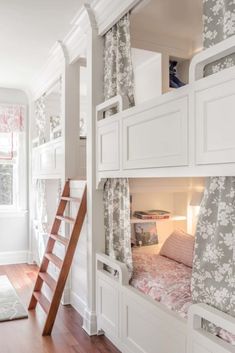 there is a bunk bed in the room with flowers on it and a ladder leading up to the second floor