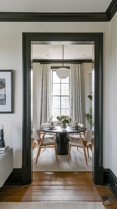 the dining room is decorated in black and white