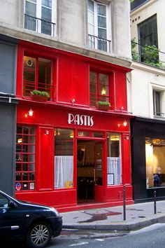 a red building with the word paris written on it's front and side windows