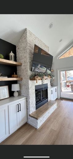 a living room filled with furniture and a flat screen tv mounted on the wall above a fireplace