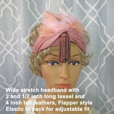 A soft wide fabric stretch headband is the base for this 1920's Flapper-inspired style. It boasts a front array of graduated 4 inch tall fluffy pink feathers and a center 2 and 1/2 inch drop tassel in pink and purple. The feathers are overall 6 inches wide. In the back there is a covered elastic band that stretches to fit a wide range of head sizes. Each of these design elements emphasizes the Great Gatsby look.  It can be worn as a classic headband, similar to how you would wear a fascinator, or across your forehead Roaring 20's Deco style as it is shown here in these photos. Either way is easy, comfortable and makes a statement.  You don't need to wait for a costume party to wear this. It is the best kind of "one size fits all" head piece for most adult woman. Fascinators and headbands a Pink Feather Trim Headpieces For Party, Pink Feathered Headpieces For Evening, Fitted Feather Headband, Great Gatsby Look, Pink Vintage Fitted Headpiece, Vintage Pink Fitted Headpieces, Adjustable Feather Trim Headband, Fitted Vintage Pink Headpiece, Fitted Flapper Style Headband