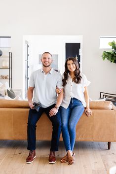 a man and woman are sitting on a couch