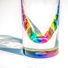 a rainbow colored glass sitting on top of a white table