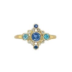 Look no further for your something blue, because this is it. The perfect dainty piece for every day or special occasions. A brilliant Sapphire is surrounded by Diamonds, Sapphires and Blue Zircons to make the perfect cluster ring. Set in 14k yellow gold with Emily's signature gold band this is definitely not a boring engagement ring. Approximate center stone size: 4mmx x 4mm Approximate tcw of diamonds: .10 ct This piece is handmade to order in Emily's Hudson Valley studio. Please allow for slig Blue Zircon Ring, Cornflower Blue Sapphire, Handmade Engagement Ring, Handmade Engagement Rings, Local Jewelry, Zircon Ring, Blue Zircon, Cornflower Blue, Something Blue