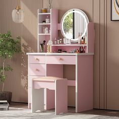 a pink vanity with mirror, stool and potted plant in front of the wall