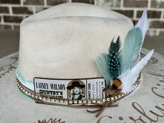 "Custom hand burned wide brimmed Boho Western Hat made to order just for you.  Colors: Cream Sand Cognac Brown Champagne  Rust (Colors not shown: Teal, Fire, Wine, Mustard, Olive) When my dad passed away, I made my mom a hat to commemorate him... with places they've traveled, songs they sung, and things that reminded her of him. I loved it so much, I made myself one with my moms favorite Bible verse, my dads ammo casing and so many things I cherish. When I posted them to my friends, I started getting others wanting a special custom hat.  One for a gift to attend a concert. We put the nickname name her Papaw gave her on the hat and a replica of her tickets with the date she was attending the concert.  Another one with a paw print to commemorate her dog Beau, and the lyrics to \"You are my S Handmade Country Style Hat Bands For Kentucky Derby, Handmade Hat Bands For Kentucky Derby, Custom Handmade Fedora For Country Events, Lainey Wilson Concert, Hat Customization, Hat Burning, Hat Bar, Lainey Wilson, Hand Burn