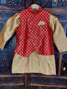 Boys 3pcs Set Kurta Pajama Set in Raw Silk Material in Gold. The Jacket is Banarasi Soft Silk with Buttis. Bottom is Balloon Style. Item : Boys Kurta Pajama Ready to Wear : Yes Kurta Color : Orange with Light Gold Jacket with floral Pattern Pajama Color : Light Gold Fabric : Raw Silk and Banarasi Soft Silk Pocket : Yes Lining : No Disclaimer - There can be little variation in the color due to screen resolution setting, phone display setting or anything else. Kindly do not hold us responsible. Fitted Bandhgala For Puja During Eid, Long Sleeve Choli With Dabka For Diwali, Chanderi Nehru Jacket With Traditional Drape For Navratri, Traditional Drape Chanderi Nehru Jacket For Navratri, Bollywood Chanderi Nehru Jacket For Navratri, Gold Chanderi Sherwani For Navratri, Gold Bandhgala For Navratri Designer Wear, Festive Nehru Jacket With Zari Work For Eid, Festive Chanderi Nehru Jacket With Zari Work