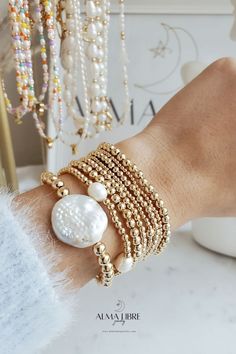 Classic gold bead bracelet is a perfect addition to a dainty stack this spring/summer season. The beads are strung on a premium stretch cord. ***SOLD BY ONE BRACELET*** ITEMS DETAILS: Water Resistant -Nickel-free - Allergy-free - - High-Quality 18K gold plated brass beads made to last - round bead size: 2mm, 3mm, 4mm, 5mm -Freshwater pearls ( due they are natural pearls may vary the size and shape) - stretchy elastic cord, no clasp Wrap Bracelet With Round Beads As Gift, Wrap Bracelet With Tiny Round Beads As Gift, Tiny Beads Wrap Bracelet As Gift, Dainty Stackable Pearl Bracelet With Round Beads, Adjustable Stackable Pearl Bracelet With Round Beads, Stackable Adjustable Pearl Bracelet With Round Beads, Hand-strung Pearl Bracelet With Round Beads As Gift, Hand-strung Round Wrap Bracelet As Gift, Hand-strung Round Wrap Bracelet Gift