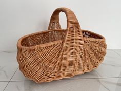 a wicker basket sitting on top of a white tile floor