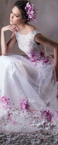 a woman in a white dress with pink flowers on it