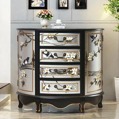 a black and white cabinet with flowers on it