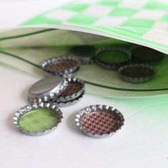 three bottle caps sitting on top of a green bag