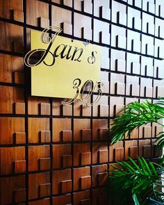 there is a sign on the wall that says lauz & co in cursive writing