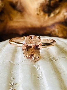 This classic 4 prong setting contains a beautiful 2.5ct. natural oval cut morganite. Morganite is a beautiful peachy pink color. The oval stone measures approximately 10x8mm. The ring is available in 14k white, yellow, or rose gold. This ring makes a great promise or engagement ring. Please send me a message if you need a size not listed. * This ring can be customized with any color center stone. All items are handmade by me in my shop in Manalapan, NJ. Please message me with any questions. Ship Oval Morganite Rose Gold Wedding Ring, Oval Morganite Rings With Accent Stones, Oval Rose Gold Morganite Wedding Ring, Classic Oval Morganite Ring, Rose Gold Oval Morganite Topaz Ring, Solitaire Morganite Oval Ring, Oval Morganite Solitaire Ring, Oval Solitaire Topaz Ring In Rose Gold, Oval Rose Gold Topaz Promise Ring