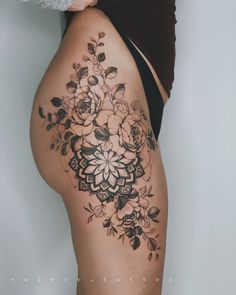 a woman's thigh with flowers on it