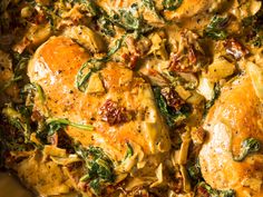 chicken and spinach casserole in a pan on the stove top, ready to be eaten