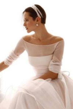 a woman in a white dress is sitting down