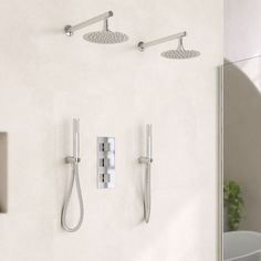 two shower faucets mounted to the side of a wall