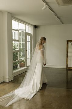 *Enjoy 10% off for a limited time. Use coupon code LIMITED10 at checkout. Does not include bespoke or custom changes. The Louvre cathedral wedding veil moves in effortless fluidity. Perfect for trailing trains on wedding dresses or gowns that need that extra length for drama.  The blusher layer creates a silhouette that demands attention yet is feather light and sheer in feel and appearance. The sheer layer of netting drapes beautifully and gracefully floats behind you as you walk. Available in Tiered Veil, Wedding Veil Cathedral, Long Wedding Veil, Cathedral Wedding Veil, Veil Cathedral