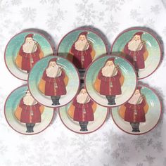 six christmas plates with santa claus on them