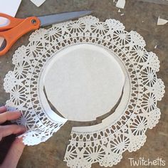 a person cutting out paper with scissors on a table