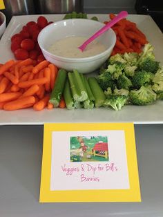 carrots, celery, and broccoli are arranged on a table