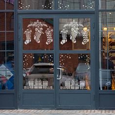 a store front with christmas decorations on the windows