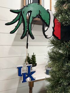 a christmas ornament hanging from the side of a tree