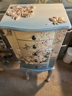 an old dresser with flowers painted on it