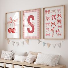 three framed pictures hang on the wall above a wooden bench with pillows and pillow cases