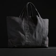 The perfect travel tote bag with an inside pocket and comfortable shoulder straps. This bag is constructed from thick, durable canvas that is ideal for travel, beach and overnight use.Additional Information:• 40% Cotton, 40% Linen, 20% Polyurethane. • Imported• Width: 29 in. Height: 21 in. • Inside Pocket Width: 12 in. Height: 11 in. • Shoulder Strap Drop: 7 1/2 in. • Spot clean. Black Cotton Weekender Bag With Large Capacity, Black Travel Bag With Canvas Lining For Daily Use, Black Weekender Bag With Canvas Lining For Daily Use, Black Cotton Weekender Bag For Everyday Use, Black Cotton Beach Bag For Travel, Black Cotton Travel Beach Bag, Travel Tote Bag, Travel Beach, Small Canvas