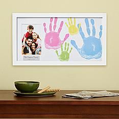 a wooden table topped with a green bowl filled with food and a framed photo on the wall