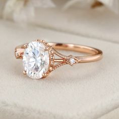 a rose gold engagement ring with an oval cut diamond