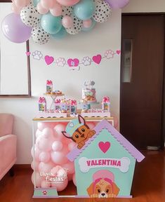 a table with balloons and decorations for a dog themed birthday party