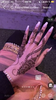 a woman's hand with henna on it