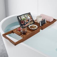 a tray with food and drinks on top of a bathtub