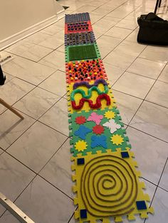 a long row of brightly colored rugs on the floor