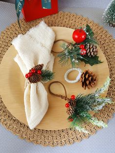 a wooden tray topped with pine cones and napkins